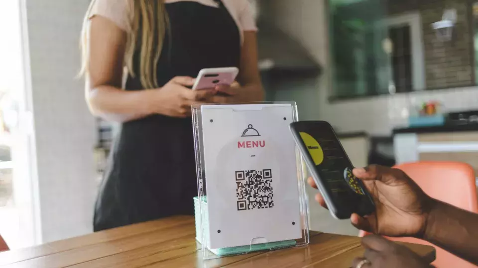 Customer scanning QR code at restaurant